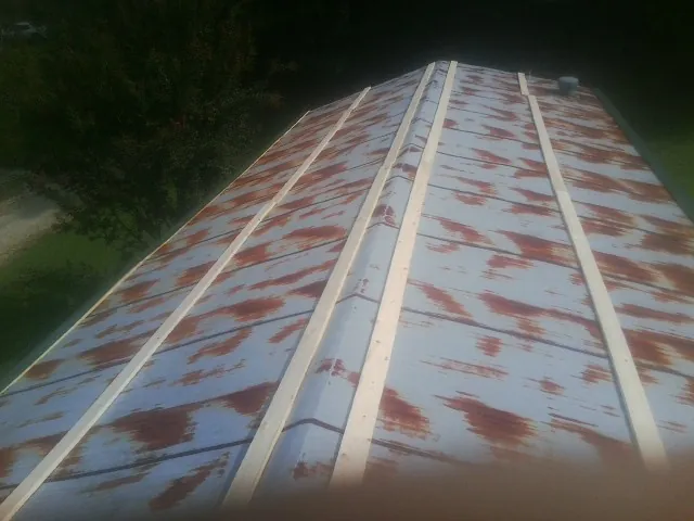 Rusted metal roof panels with new wood purlins before replacement — Storm Damage Roof Repair in Bushkill by Roofing Brothers