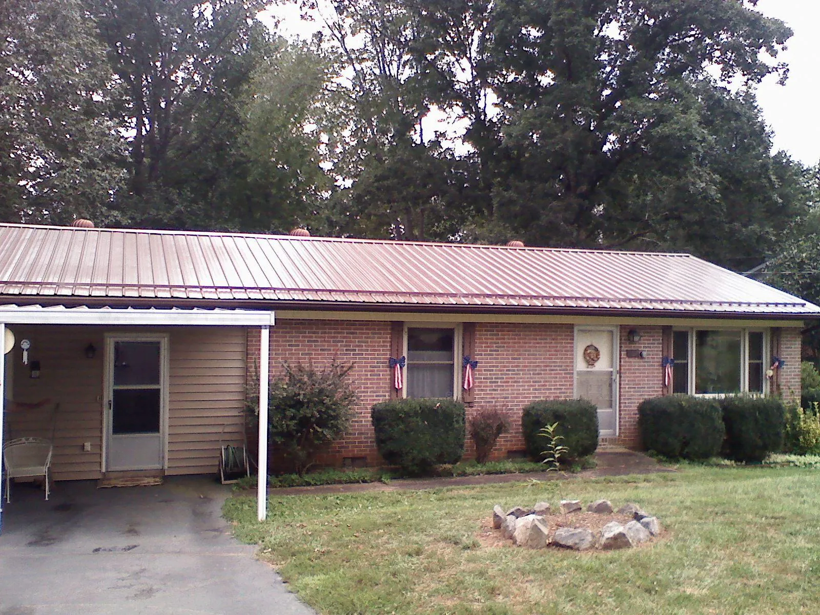 Bronze metal roof and carport on a brick ranch home — Roof Repair work by our crew in Bushkill