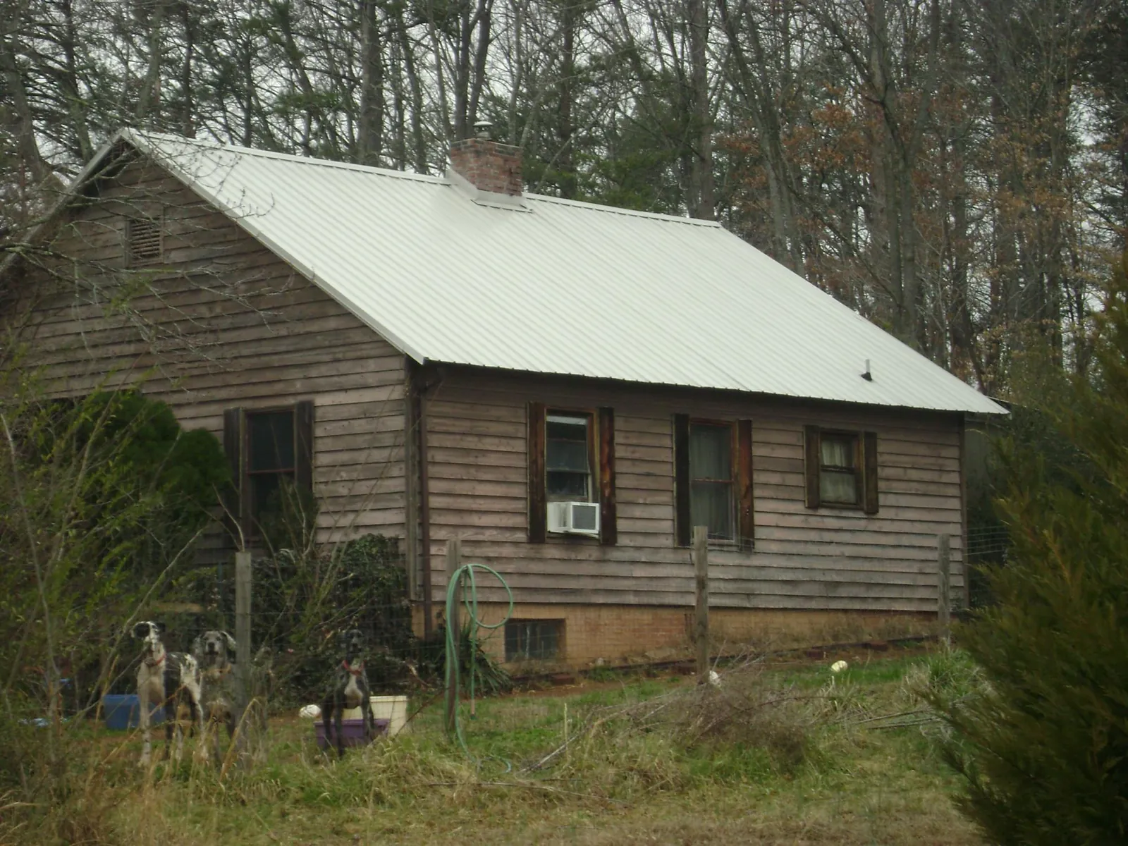 White metal roof on an old wood sided farmhouse, from a Metal Roof Installation job in Bushkill